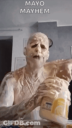 A Man Covered In Mayonnaise Is Holding A Jar Of Mayonnaise . GIF