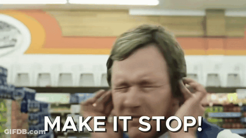 A Man Covering His Ears In A Store With The Words Make It Stop Written Below Him GIF