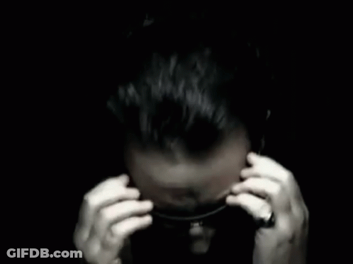 A Man Covering His Ears With His Hands In A Black And White Photo . GIF