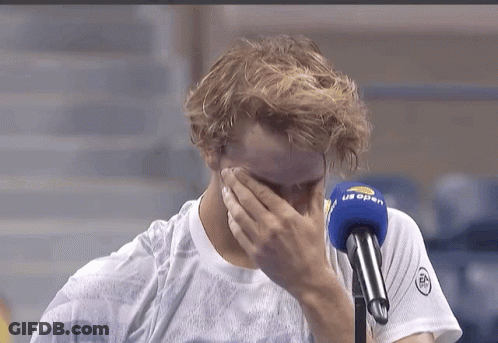 A Man Covering His Face In Front Of A Microphone That Says ' Us Open ' On It GIF