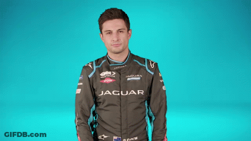 A Man Covering His Face With A Black And White Checkered Flag With The Letter S On It GIF