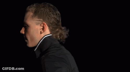 A Man Covering His Face With A Mask With Flames Coming Out Of It GIF
