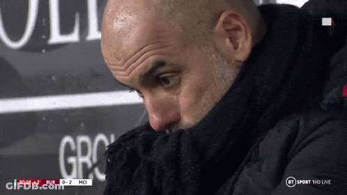 A Man Covering His Face With A Scarf In Front Of A Bt Sport Hd Live Sign GIF