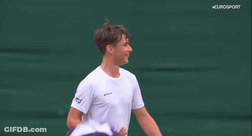 A Man Covering His Face With A Towel While Holding A Tennis Racquet On A Eurosport Screen GIF
