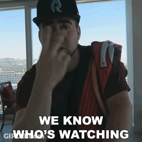 A Man Covering His Face With His Hand And The Words We Know Who 'S Watching Below Him GIF