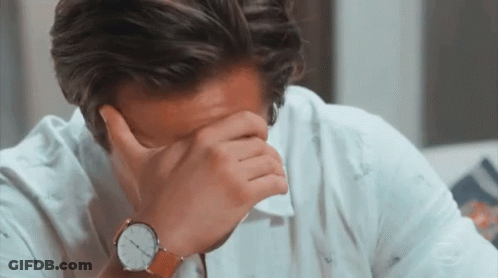A Man Covering His Face With His Hand Wearing A Watch GIF