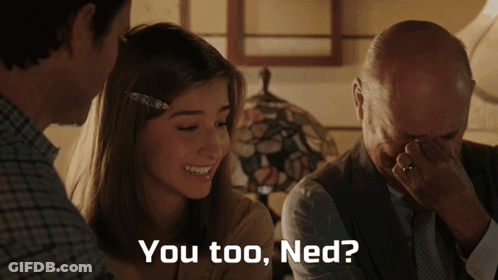 A Man Covering His Face With His Hand While A Woman Smiles And The Words You Too Ned Are Displayed GIF