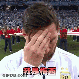 A Man Covering His Face With His Hands In Front Of A Crowd Of People . GIF