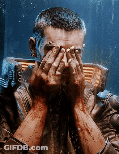 A Man Covering His Face With His Hands While Wearing A Jacket That Says Cyberpunk On It GIF