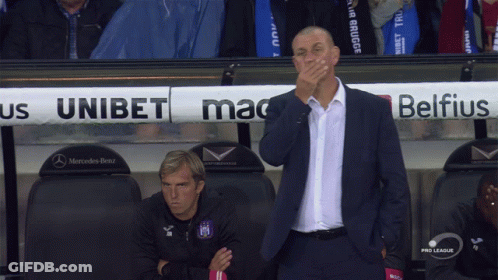 A Man Covering His Mouth In Front Of A Mercedes Benz Sign GIF
