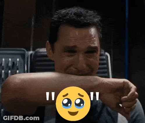 A Man Covering His Mouth With His Hand And A Smiley Face With Tears On It GIF