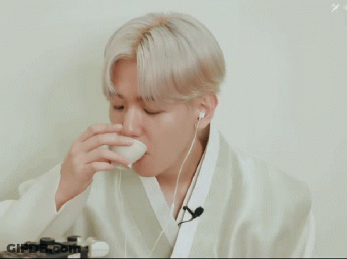 A Man Covering His Mouth With His Hand And The Words Argh So Hot Written Below Him GIF