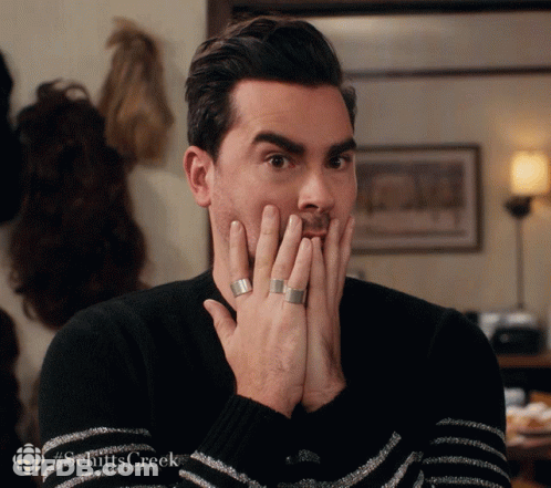 A Man Covering His Mouth With His Hands With A #Schittscreek Logo In The Corner GIF