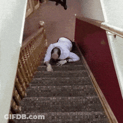 A Man Crawling Down A Set Of Stairs With A Railing GIF