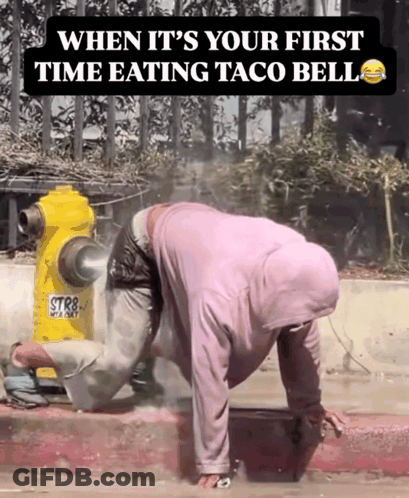 A Man Crawling On The Sidewalk Next To A Yellow Fire Hydrant That Says Str8 GIF