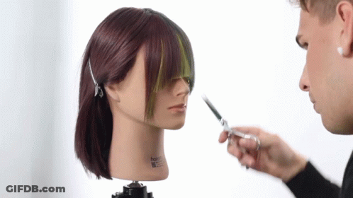 A Man Cutting A Mannequin 'S Hair With A Pair Of Scissors GIF