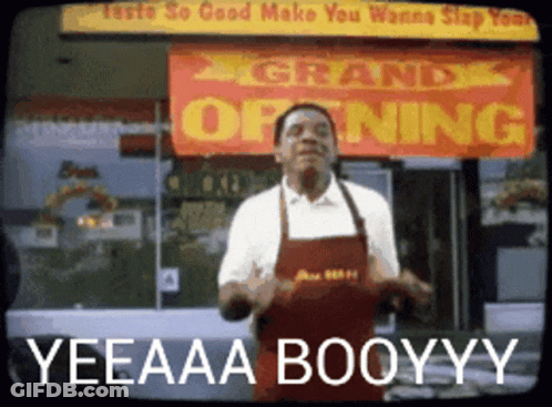 A Man Dancing In Front Of A Sign That Says Grand Opening GIF