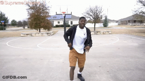 A Man Dancing On A Basketball Court With Supreme Dreams Written On The Bottom Right GIF
