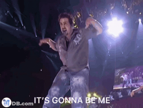 A Man Dancing On Stage With The Words It 'S Gonna Be Me Above Him GIF