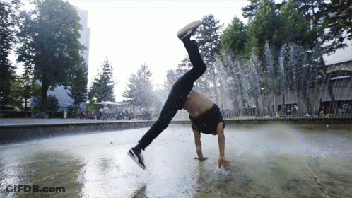 A Man Does A Handstand In A Fountain GIF