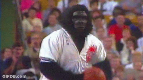 A Man Dressed As A Gorilla Holding A Basketball GIF