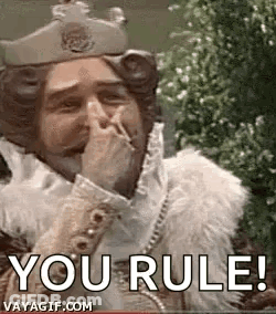 A Man Dressed As A King Is Covering His Mouth With His Hand And Smoking A Cigarette . GIF