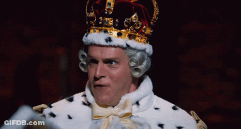 A Man Dressed As A King With A Crown On Top Of His Head GIF