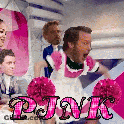 A Man Dressed As A Maid Is Surrounded By Pink Cheerleaders GIF