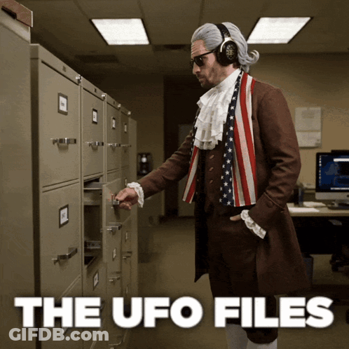 A Man Dressed As Benjamin Franklin Pulls A Drawer Out Of A Filing Cabinet GIF