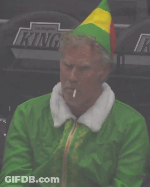 A Man Dressed As Buddy The Elf Smoking A Cigarette In A Stadium GIF