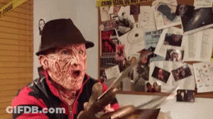 A Man Dressed As Freddy Krueger Holding A Knife GIF