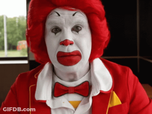 A Man Dressed As Mcdonald 'S Clown With Red Hair And White Face Paint GIF
