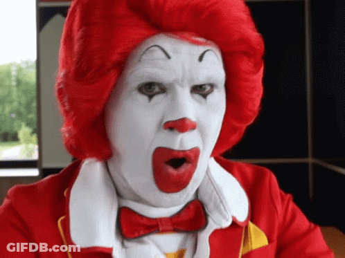 A Man Dressed As Mcdonald 'S Ronald Mcdonald With A Surprised Look On His Face GIF