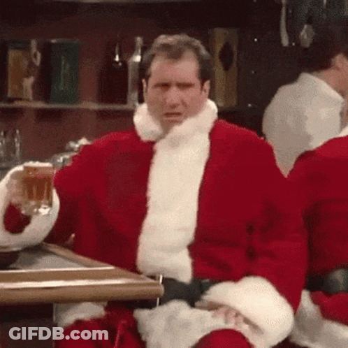 Santa Sitting At Table With Beer GIF
