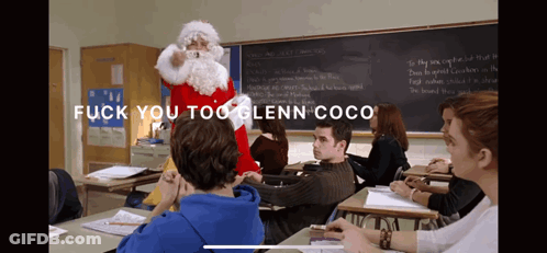 A Man Dressed As Santa Claus Stands In Front Of A Classroom With The Words " Fuck You Too Glenn Coco " On The Bottom GIF