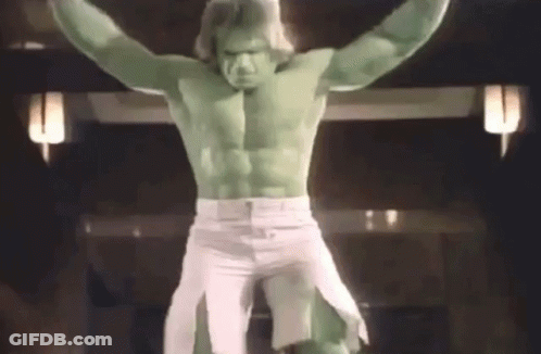 A Man Dressed As The Hulk Is Standing On A Cross With His Arms Outstretched GIF