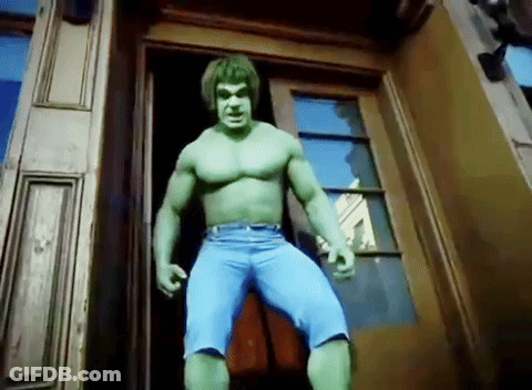 A Man Dressed As The Incredible Hulk Is Standing In A Doorway GIF