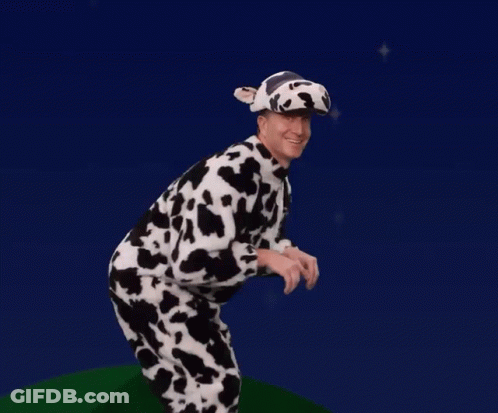 A Man Dressed In A Cow Costume And Hat GIF