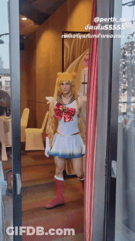 A Man Dressed In A Sailor Moon Costume Stands In A Doorway GIF