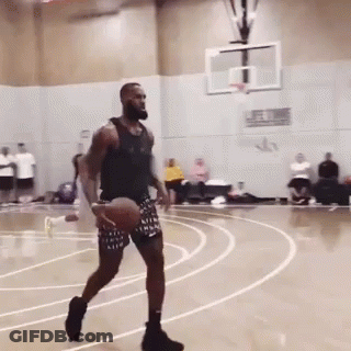 A Man Dribbles A Basketball On A Court With The Word Nike On His Shorts GIF