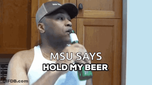 A Man Drinking A Beer With The Words Msu Says Hold My Beer Below Him GIF