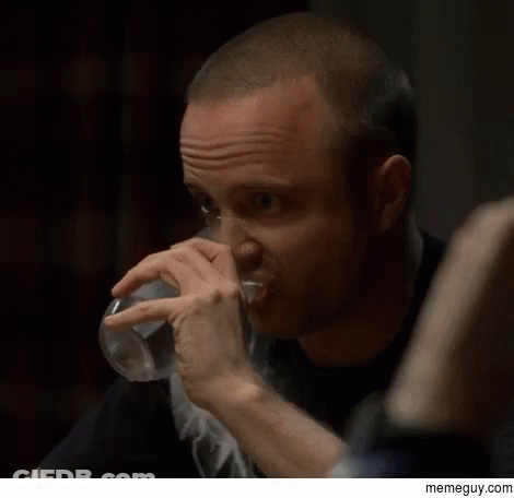 A Man Drinking A Glass Of Water With A Memeguy.com Watermark On The Bottom GIF
