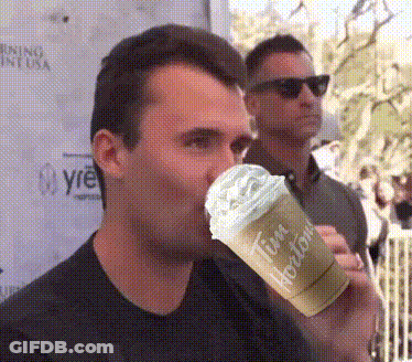 A Man Drinking A Tim Hortons Drink With Whipped Cream GIF