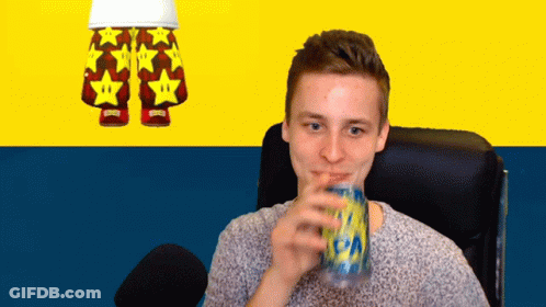 A Man Drinking From A Can With A Pair Of Shorts With Stars On Them In The Background GIF