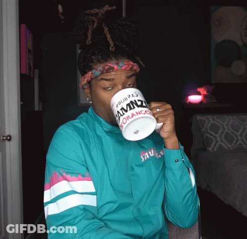 A Man Drinking From A Mug That Says Amnz On It GIF