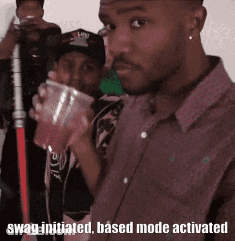A Man Drinking From A Plastic Cup With The Words Swag Initiated Based Mode Activated On The Bottom GIF