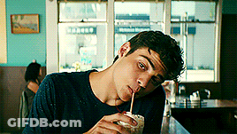 A Man Drinking Through A Straw In A Diner GIF