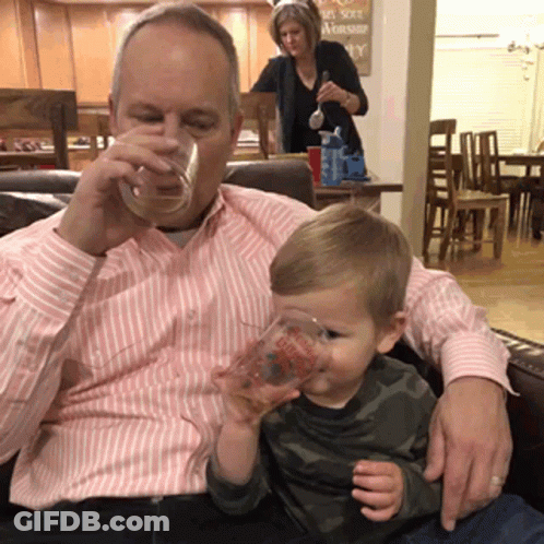 A Man Drinks From A Glass While A Little Boy Drinks From A Cup That Says " I Love You " On It GIF