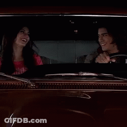 A Man Driving A Car With A Woman Sitting In The Back Seat GIF