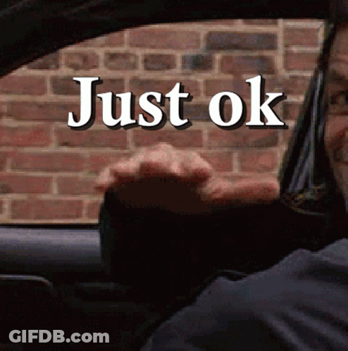 A Man Driving A Car With Just Ok Written On The Window GIF